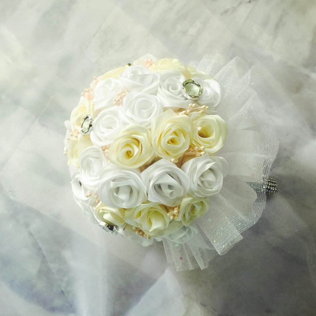 Beautiful bridal bouquet with white and cream artificial roses, perfect for weddings.